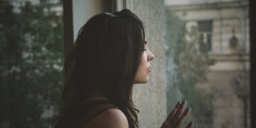woman sitting alone in the dark thinking about being the other woman