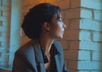 Woman looking out the window feeling emotionally drained in a toxic relationship with a narcissist.